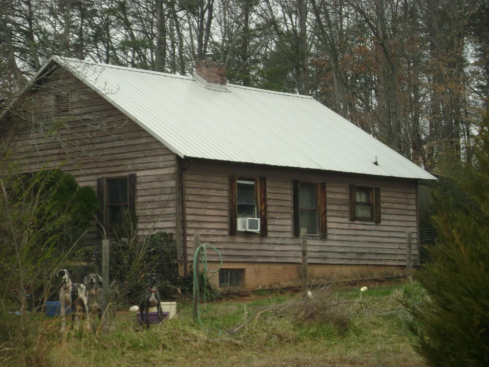 White metal roof on an old wood sided farmhouse, from a Metal Roof Installation job in Mccordsville